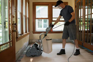 Professional drum sander mid-refinish on an Inland Empire hardwood floor