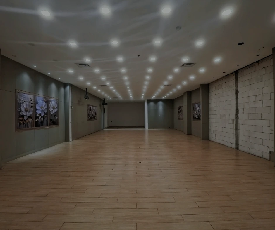 Wide-angle view of a large commercial space with wood-look flooring installed by Monteros