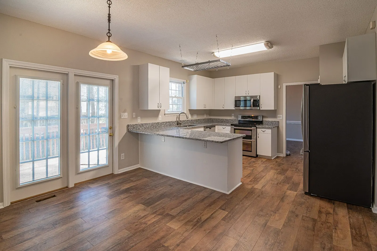 Luxury vinyl plank kitchen floor installed after tile removal
